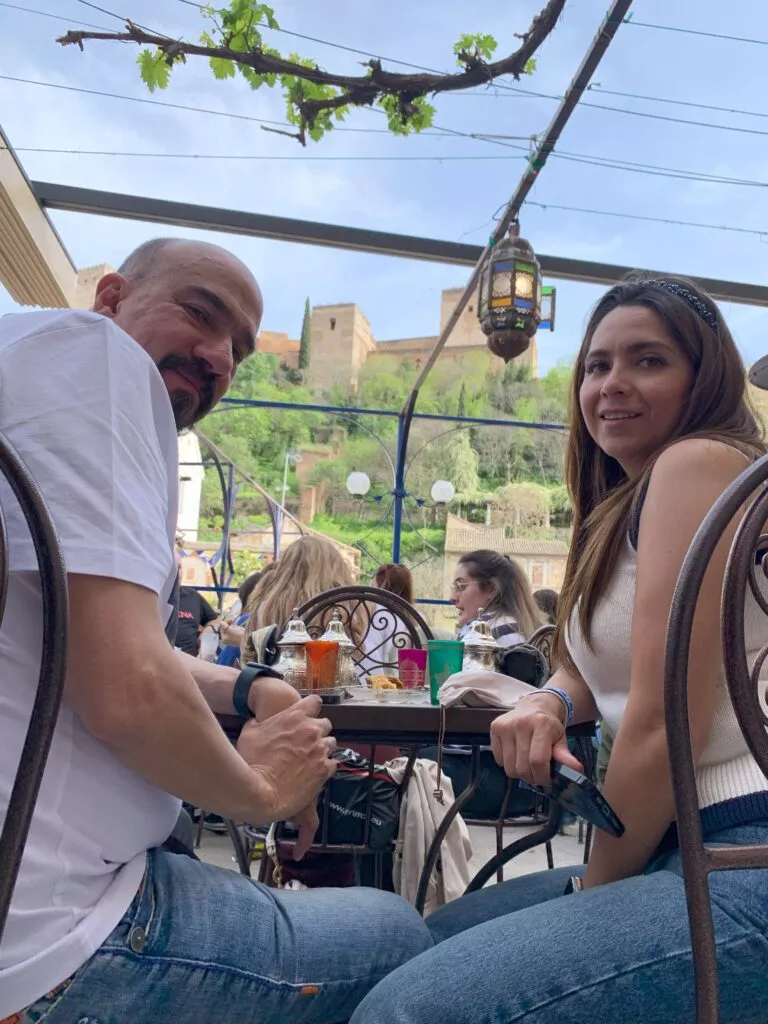 Mexican couple eating at a restaurant in fron of the Alhambra, Granada, Spain